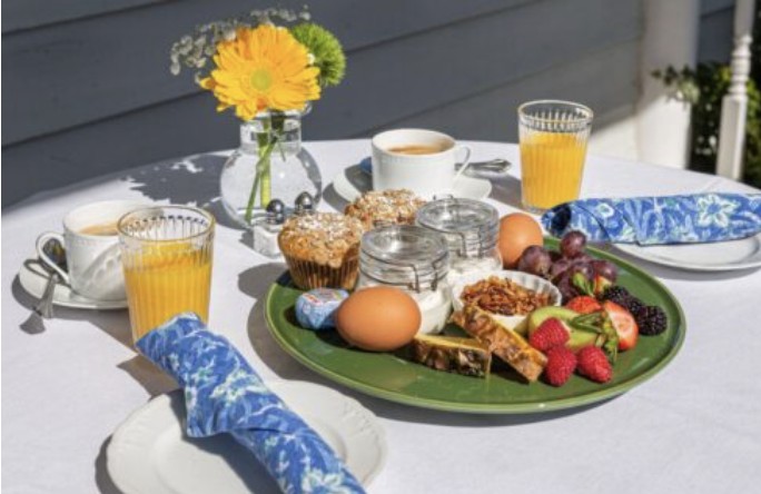 Breakfast platter with fresh fruit, house-made granola and pastries on the veranda table