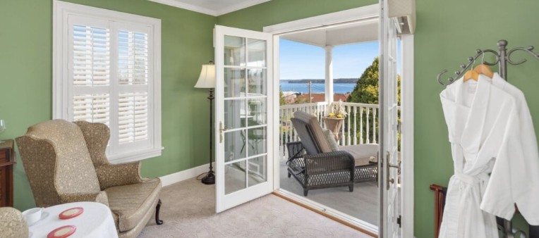 Bay Room — French doors opening to the upper veranda and Townsend Bay